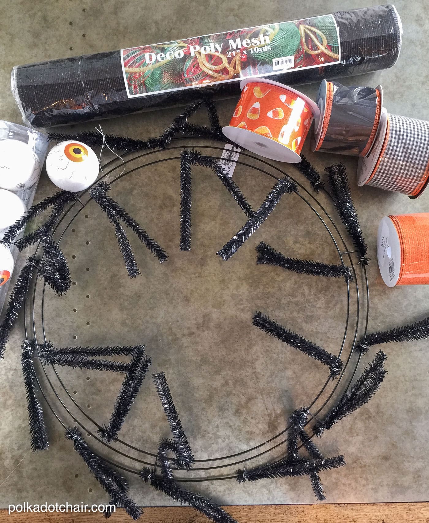 How to make a cute Halloween Eyeball wreath for your front door out of Geo Mesh and ribbon. 