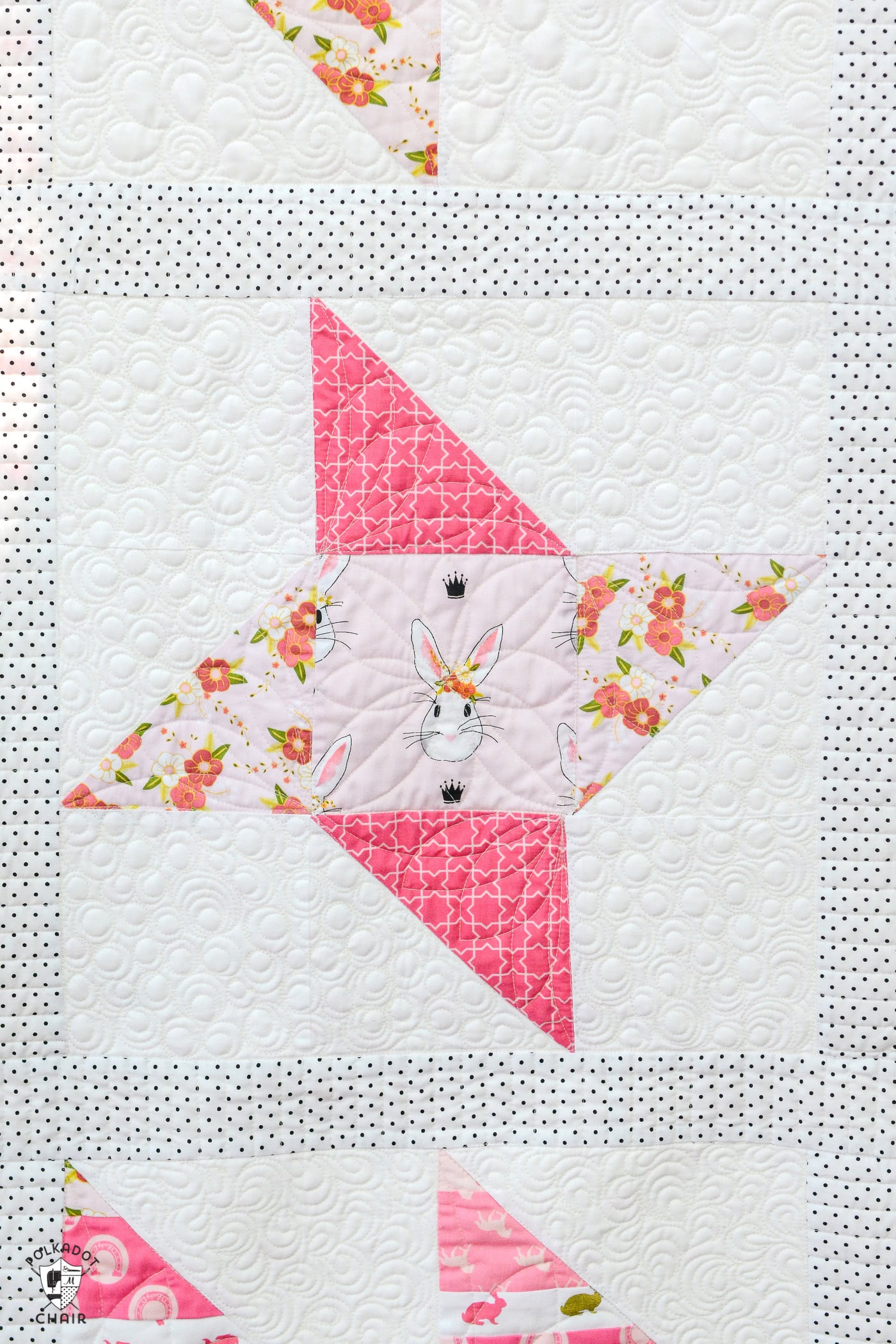 pink quilt block sewn into quilt