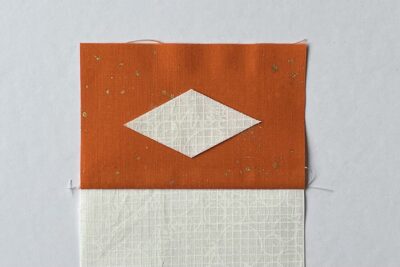 cream diamond on orange fabric