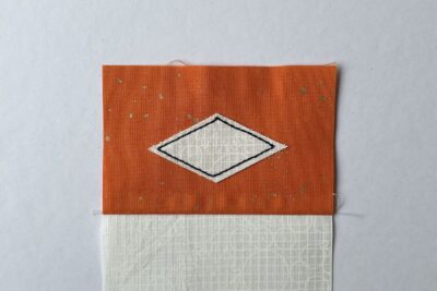 black top stitching on orange and cream fabric