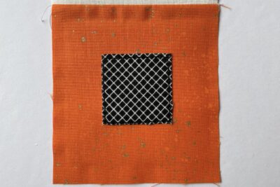 black fabric on orange fabric