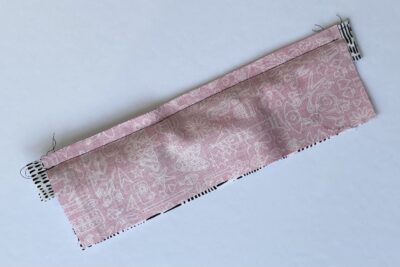 gray zippered bookmark construction process photo - fabric on white table with sewing notions