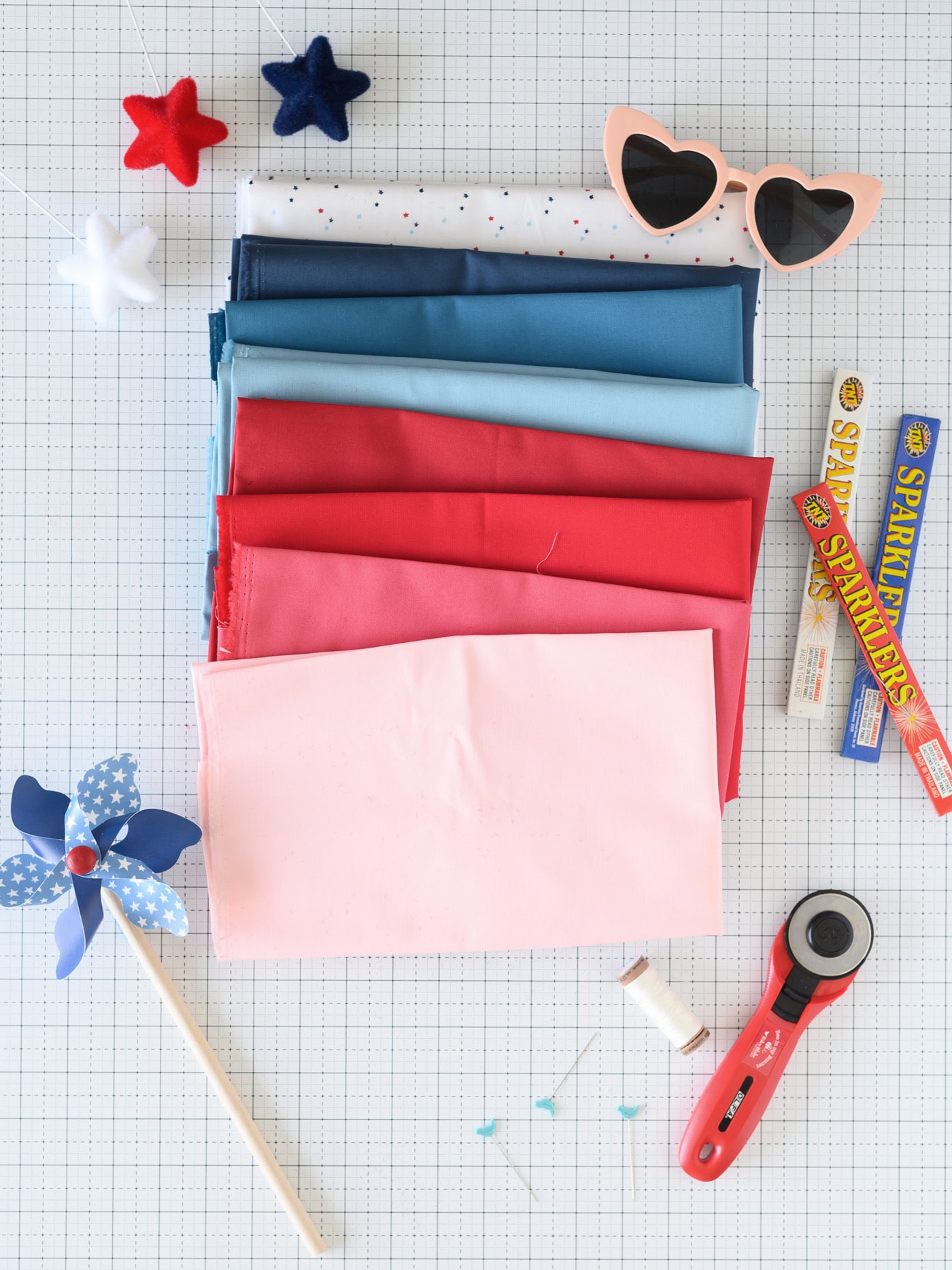 pink and blue fabric on white cutting mat with summer notions