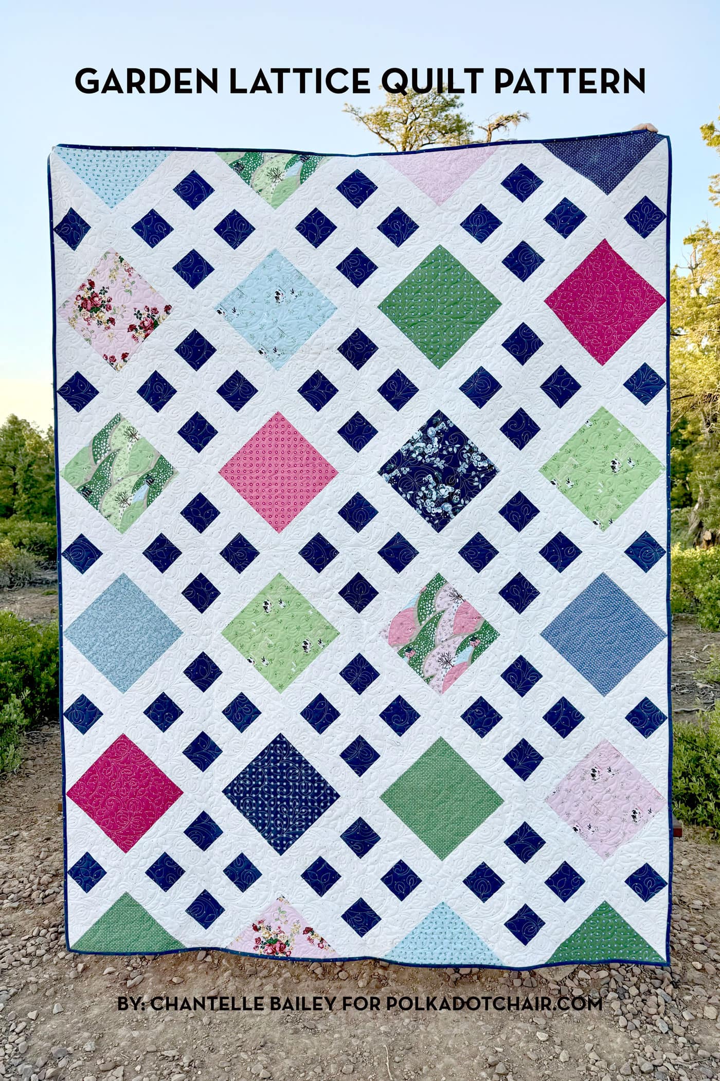 close up of patchwork quilt in pink, white navy & green