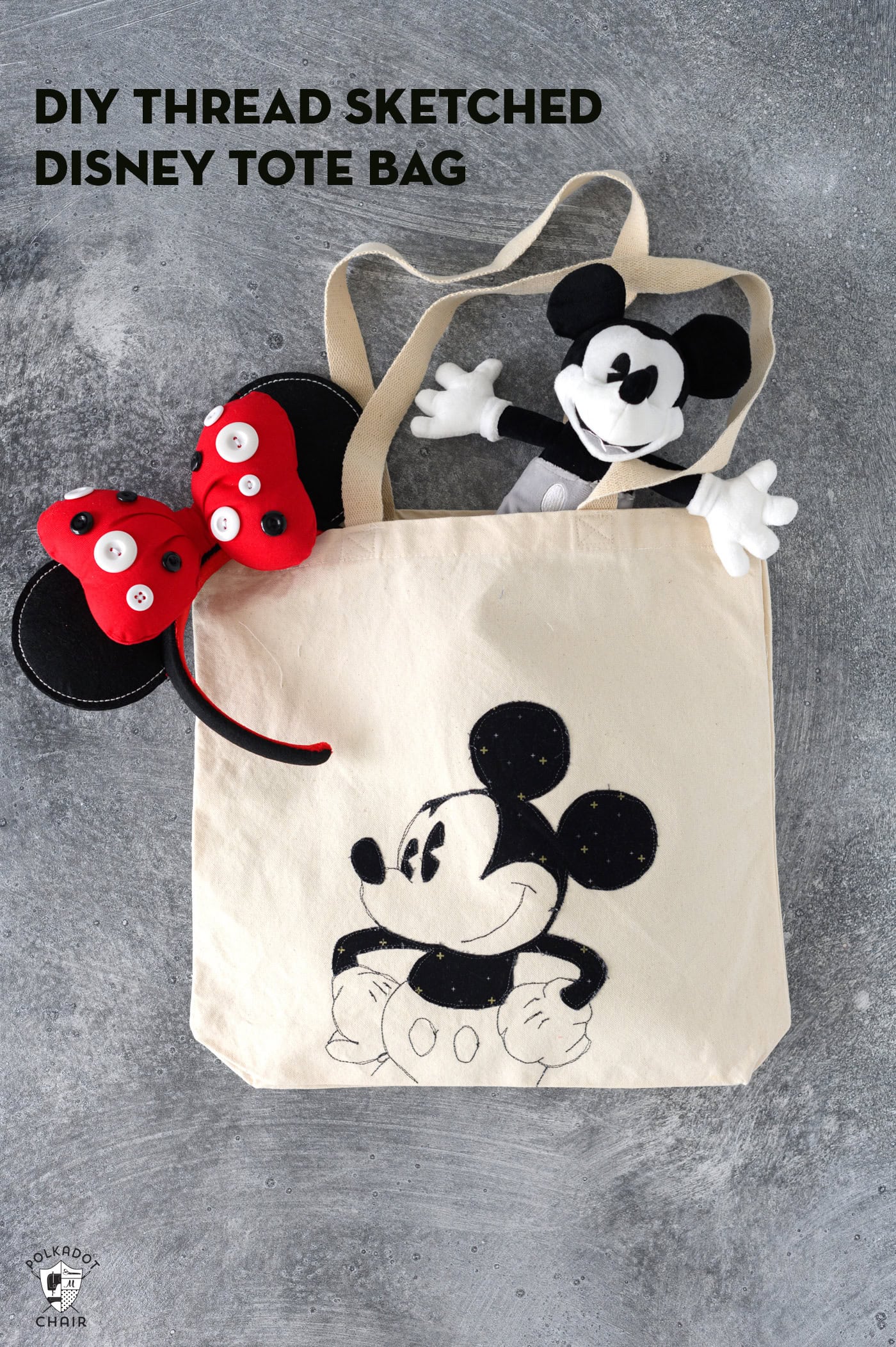 Applique tote bag with Mickey Mouse on front with mickey mouse doll and disney minnie ears on gray table