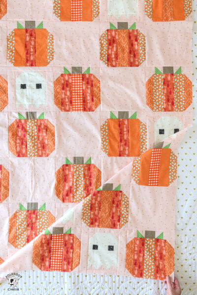 pink quilt with orange striped pumpkins and ghosts