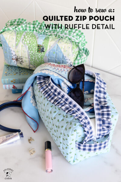 image of two ruffle zip pouches with scarf, and lip gloss on white table