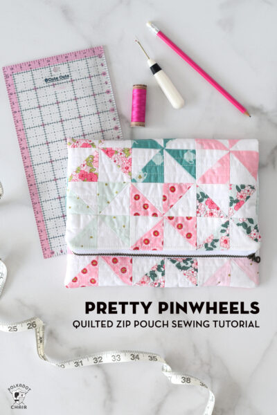 quilted pinwheel fold over zip pouch on white table with sewing notions